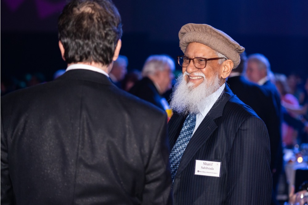 Sharif Sahibzada speaking with guest